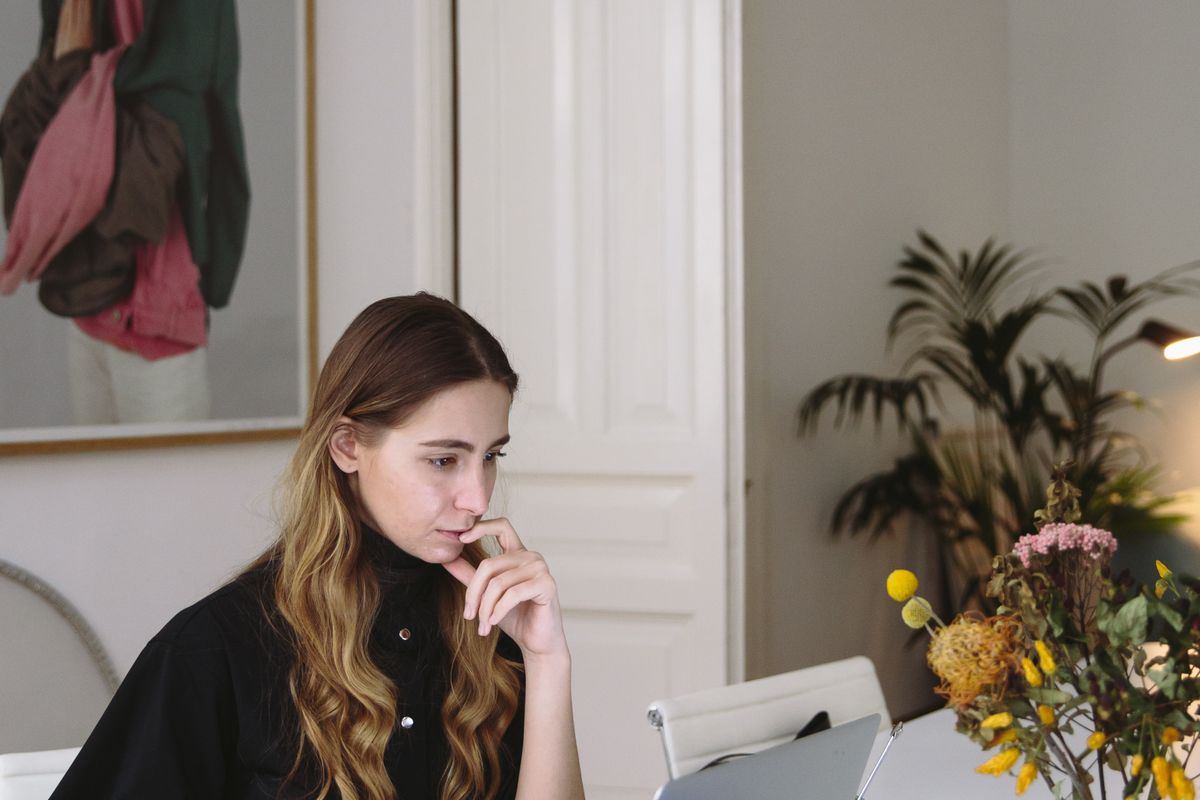 Professional focused on laptop work in a modern office