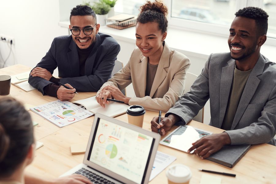Advisory team in a bright meeting discussing charts and notes