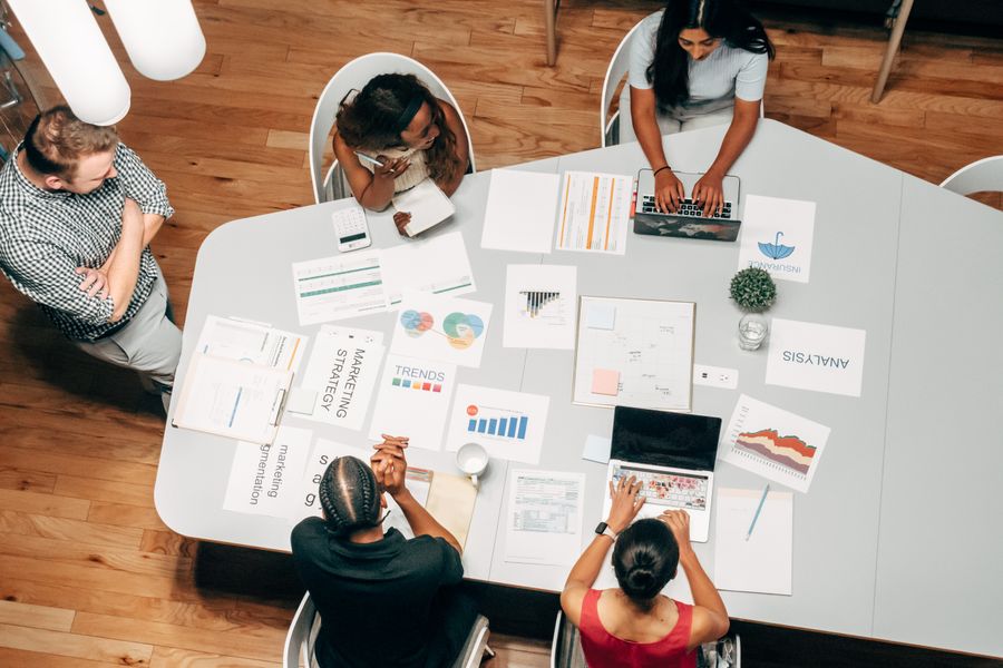 Team reviewing strategy documents and charts around a meeting table